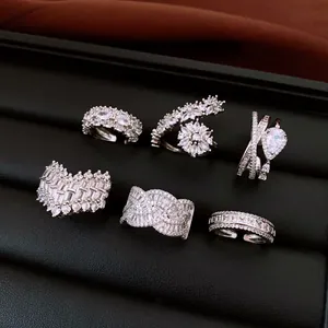 Close-up of sparkling silver rhinestone rings collection on a black jewelry tray
