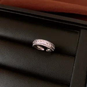 Close-up of a sparkling silver rhinestone ring nestled in a black leather jewelry box