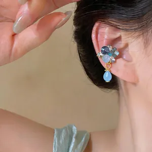 Close-up detail of a French retro rhinestone water drop ear cuff worn on the ear bone