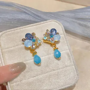 Detailed close-up of French vintage clip-on earrings with blue crystals and teardrop beads