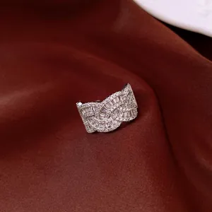 Detailed view of an intricate silver-colored ring with baguette and round-cut crystals