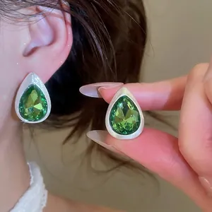 Vintage-style green crystal waterdrop earrings with a brushed silver-tone metal finish