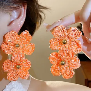 Statement orange raffia woven double flower drop earrings for summer vacation style