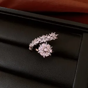 Macro view of an intricate silver floral ring with sparkling rhinestones on leather.