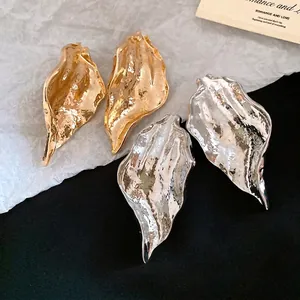 Minimalist textured leaf-shaped stud earrings in elegant gold and silver finishes for women