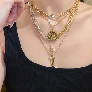 Multi-layered retro metal necklace with coin and horn pendants for a vintage luxury look.