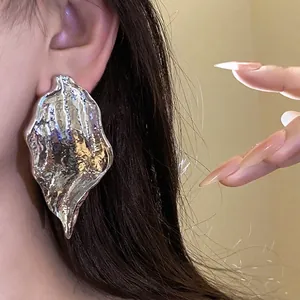 Elegant silver needle earrings with a crumpled metallic leaf pendant and a high-gloss finish.