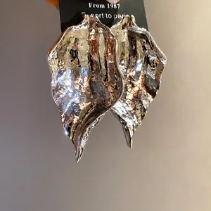 Elegant silver-colored pleated leaf pendant earrings featuring a textured hammered finish