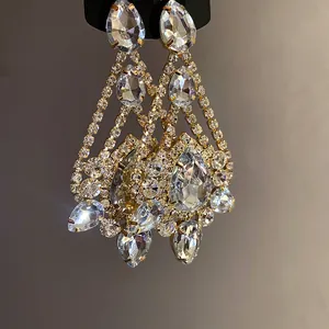 Detailed macro view of luxurious crystal water drop earrings with sparkling rhinestones