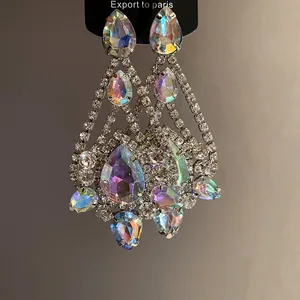 Detailed view of iridescent teardrop crystal earrings with silver-toned rhinestone setting