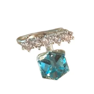 Elegant silver ear cuff with blue sugar cube zircon and sparkling pavé accents.
