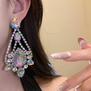 Detailed close-up of luxurious sparkling iridescent teardrop earrings with rhinestone inlay