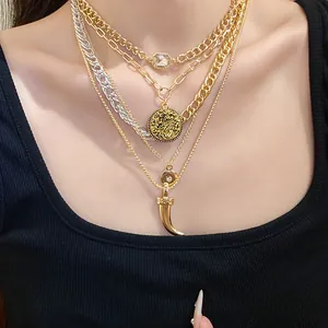 Retro chunky layered gold necklace set with textured coin and horn shaped pendants for women