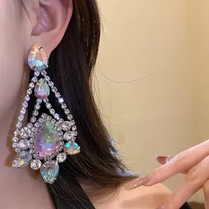 Close-up of elegant iridescent teardrop dangle earrings with sparkling rhinestones.