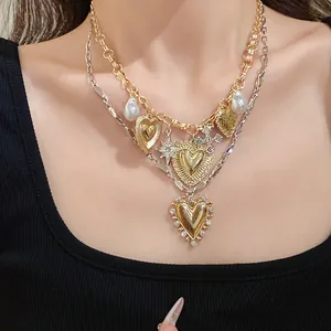 Detailed macro view of vintage layered gold heart necklace with pearls and rhinestones