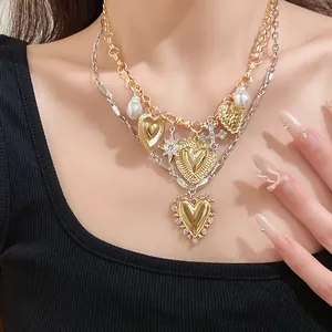 Detailed view of a vintage double-layer necklace with heart and pearl charms