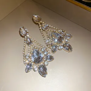 Elegant teardrop crystal dangle earrings with sparkling rhinestones in a luxury gold finish.