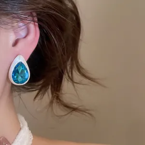 Detailed view of elegant blue teardrop crystal stud earring in retro brushed silver