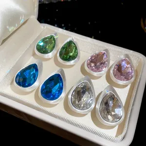 Detailed macro view of multi-color waterdrop crystal earrings in brushed silver base