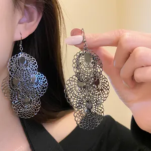 Detailed view of oversized gunmetal filigree openwork earrings for a stylish statement look.