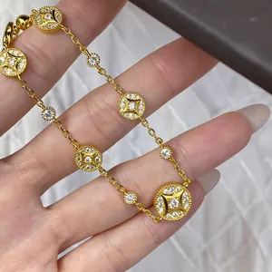 Detailed close-up of an 18k gold plated circular bracelet featuring sparkling zircon stones