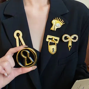 Close-up macro view of luxury vintage gold surrealist brooches pinned on a black blazer