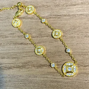 Detailed view of an 18k gold plated bracelet featuring elegant round CZ encrusted charms