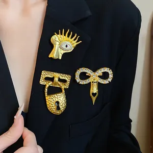 Macro view of three exquisite vintage gold brooches with zircon set on a black designer blazer