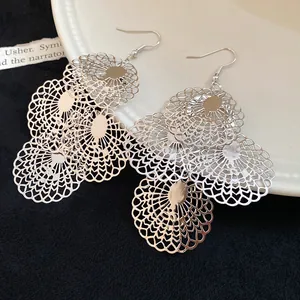 Detail view of silver layered lace hollow circular dangle earrings with fishhook