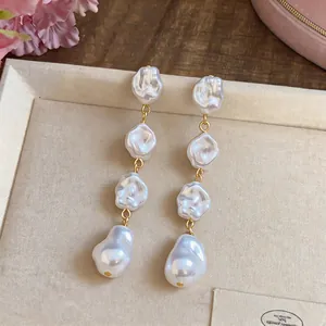 Eleganti orecchini lunghi con quattro perle barocche irregolari e montatura dorata