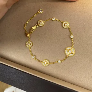 Detailed close-up of a luxurious 18k gold plated bracelet featuring zircon-set charms.