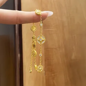 Detailed macro view of 18k gold plated bracelet with zircon-encrusted round charms