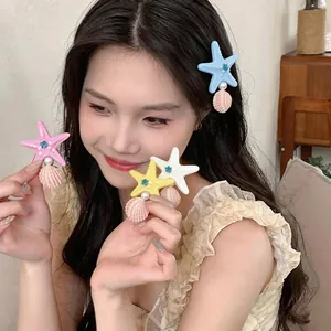 Detailed view of starfish and shell hair clips with pearls worn by model for beach style