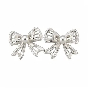 S925 silver needle hollow-out bow-knot stud earrings featuring elegant white pearl centers