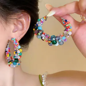 Detailed view of colorful glass beaded hoop earrings with vibrant dopamine style