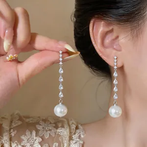 Detail shot of elegant tassel earrings with water drop cubic zirconia and pearl drops