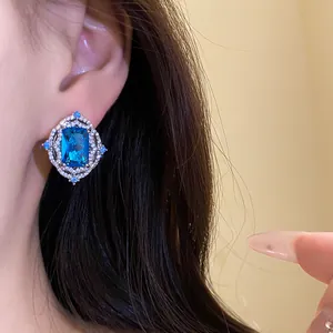 Close-up of vintage royal style earring with a large rectangular blue zircon stone