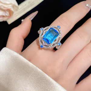 Close-up of vintage palace style open ring with a large blue square zircon gemstone