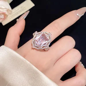 Close-up of a vintage court style zircon ring with rectangular gemstone on finger