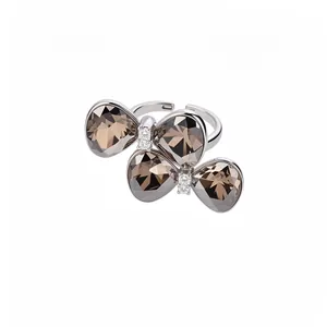 Elegant silver open ring featuring a double butterfly bow with brown crystal accents