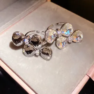 Detailed macro view of elegant rhinestone bow open rings featuring silver and grey crystals