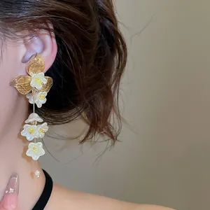 Detailed close-up view of elegant French style flower tassel earrings with delicate pearl drops