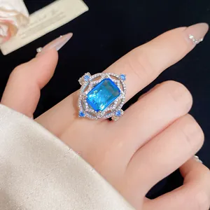 Close-up of retro palace style ring with rectangular blue zircon gemstone
