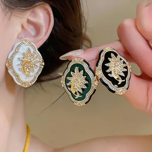 Detailed view of vintage court style flower stud earrings with crystals in multiple colors