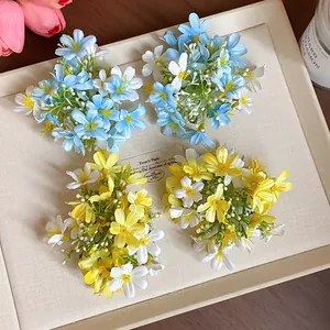 Close-up of elegant blue and yellow fabric flower duckbill hair clips for spring