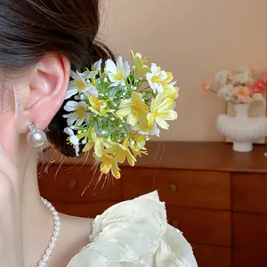 Close-up of fresh fabric flower hair clip worn by a model for a spring look