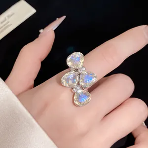 Elegant close-up of a crystal bow-knot open ring with sparkling stones on a hand.
