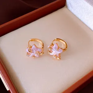 Close-up detail showing texture of pink star zircon earrings in a premium jewelry box