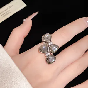 Elegant close-up of a smoky gray crystal bow ring with sparkling rhinestone accents.