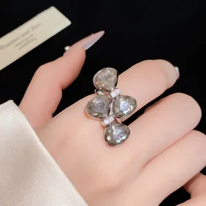 Close-up of elegant bowknot ring with grey faceted stones and crystal accents